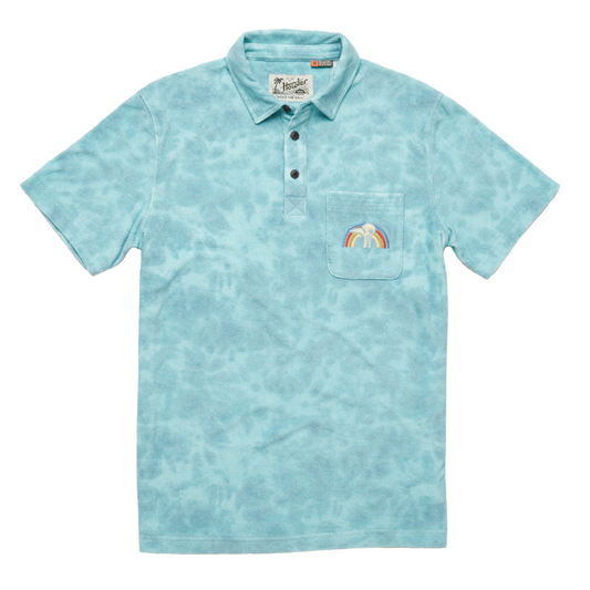 A blue terry cloth polo shirt with a rainbow embroidered on the front right pocket.